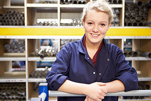 female apprentice in workshop looking at camera