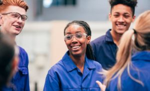 Young engineers of different backgrounds mingle in the workshop.