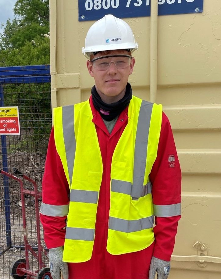 Liam McShane, apprentice pipefitter with Laker-Vent engineering stands outside container in full PPE.