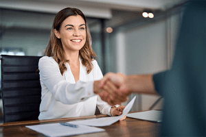 AdobeStock_637048304 Woman shaking a man's hand in agreement