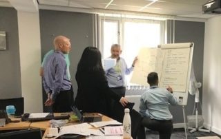 NUVIA team on leadership programme writing on flipchart