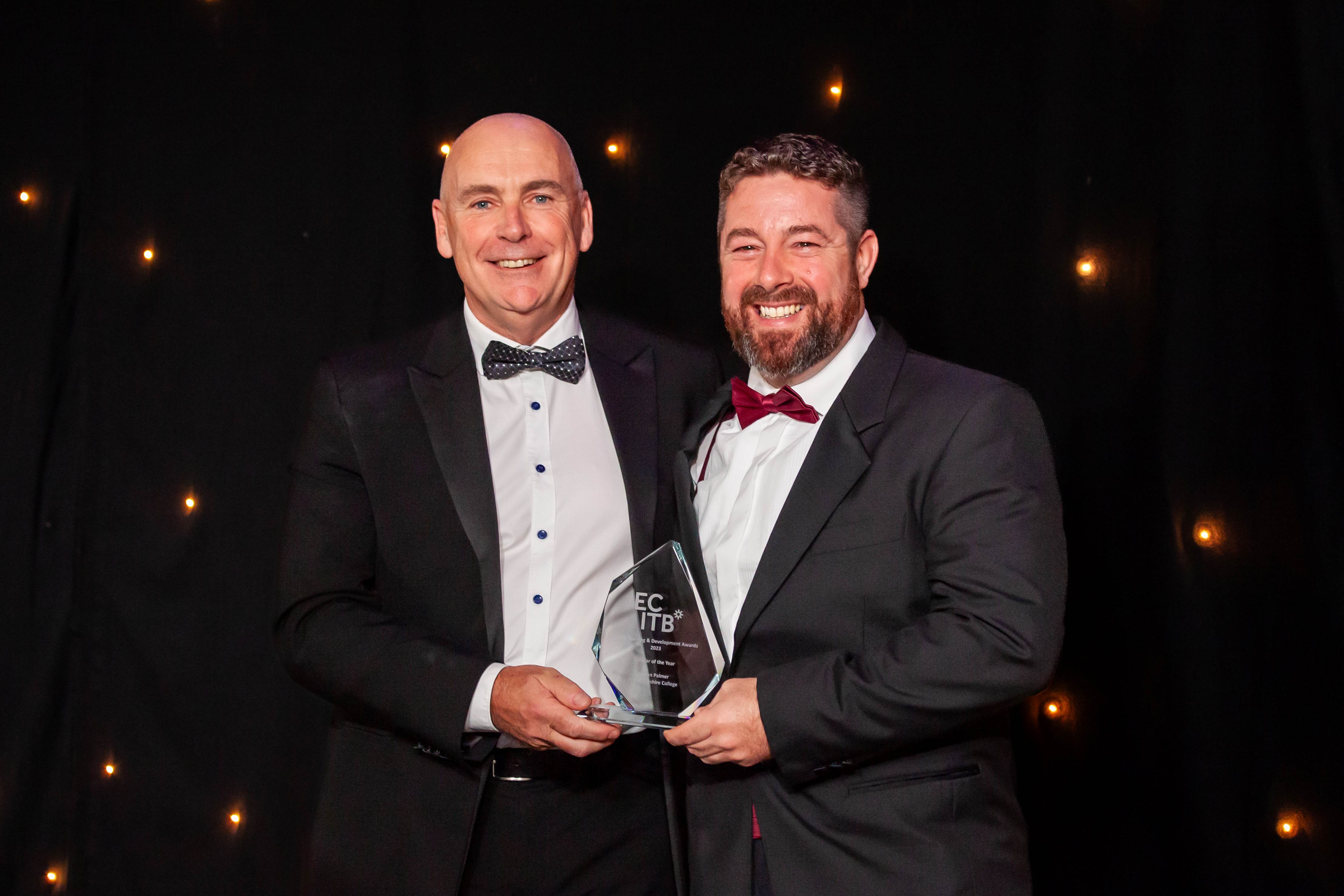 Arwyn Williams from Pembrokeshire College collecting the scholar of the year award on behalf of Jordan Palmer with Paul Smith from Cavendish Nuclear who sponsored the award