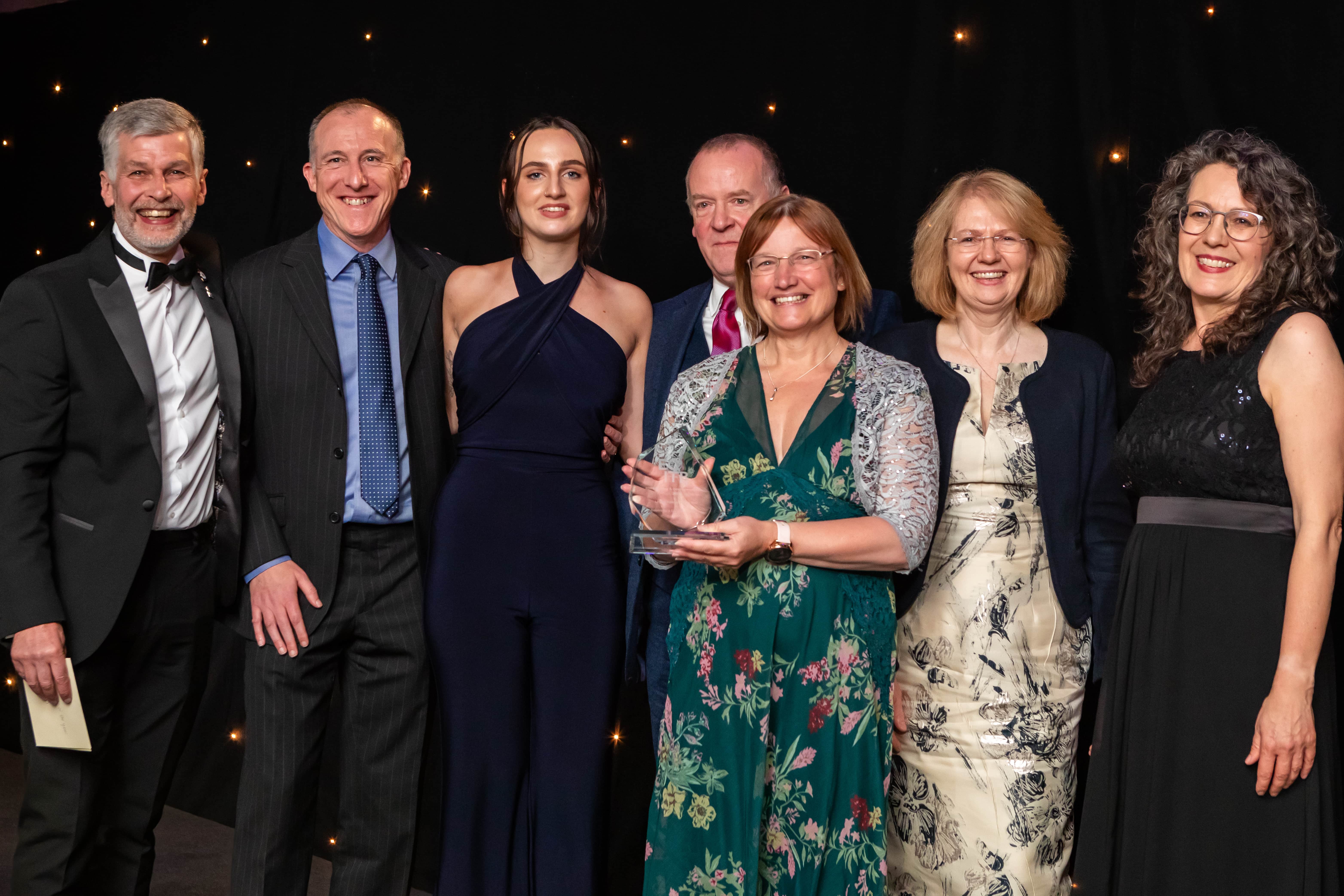 Rhona Gill from Dounreay collecting the awards at the ECI Awards 23 with Andrew Hockey, Mark Booth from sponsor- CATCH and host Kate Bellingham