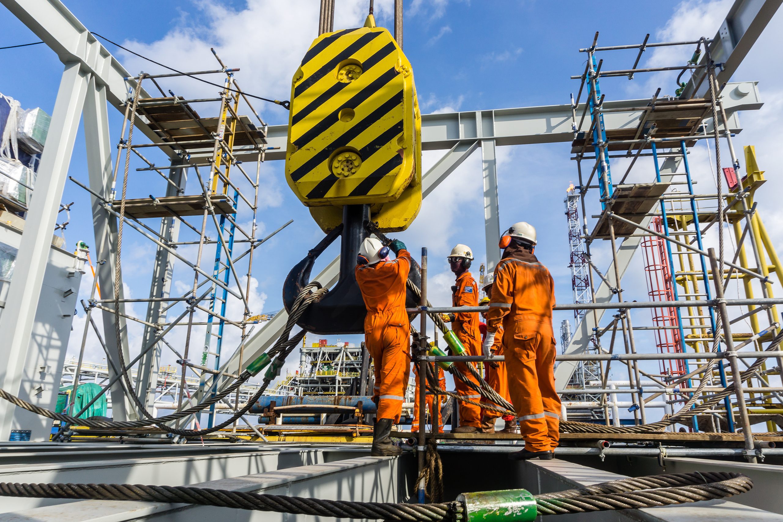 Offshore Workers Performing Inspection To A Crane Hook And Rigging Arrangement Prior To Heavy Lift