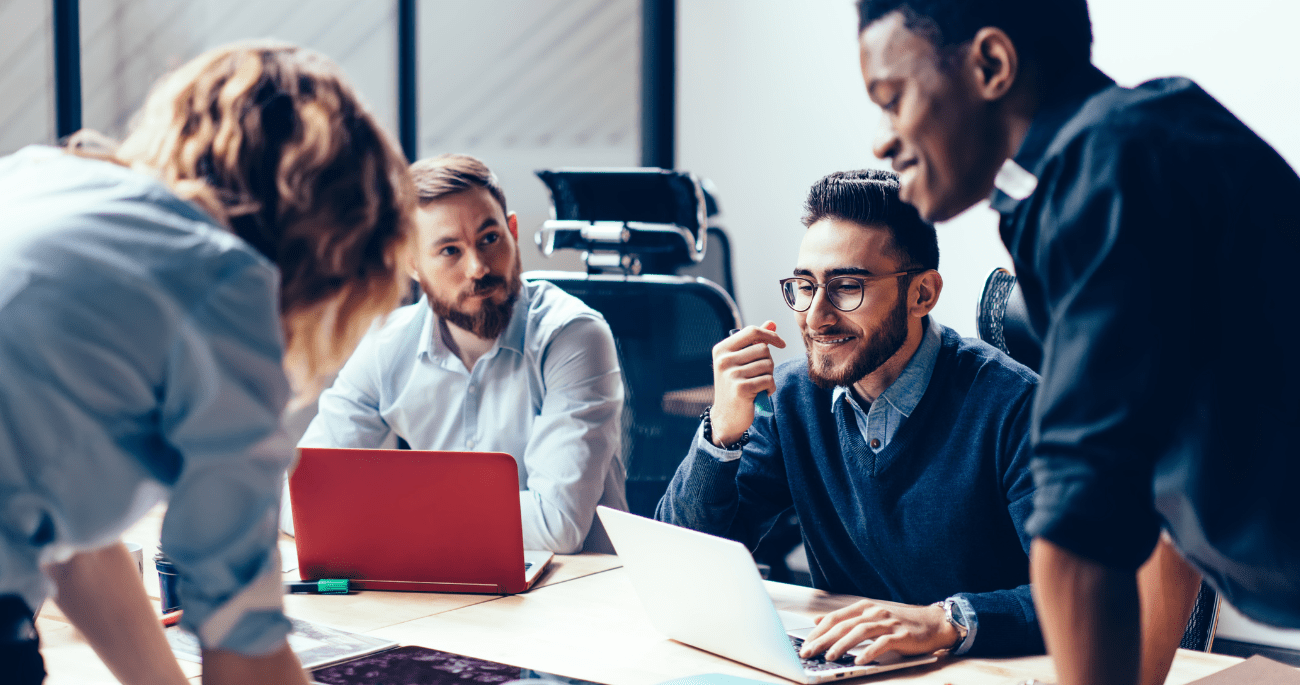 Group Of People Working At A Desk On Laptops Aspect Ratio 760 400