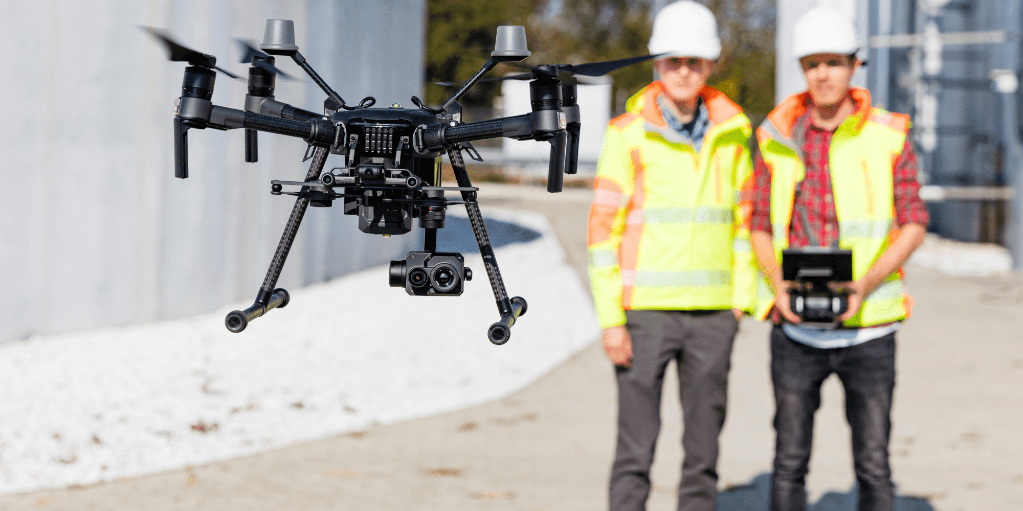 Industrial Drone  Two People Flying A Drone Around An Industrial Site Aspect Ratio 1160 580