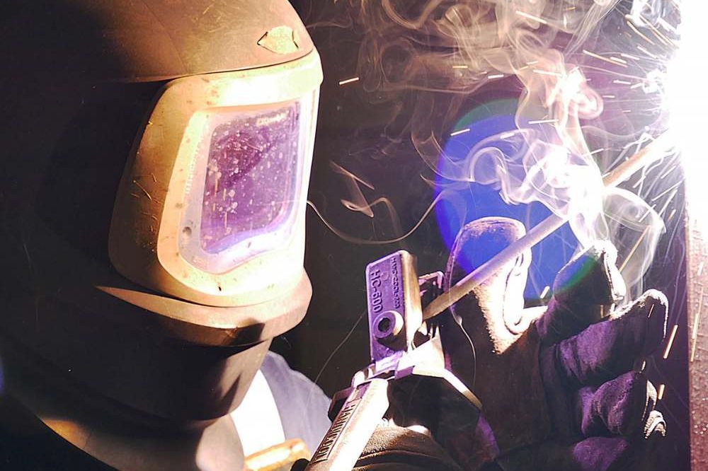 Person Welding In A Metal Helmet Aspect Ratio 1200 800
