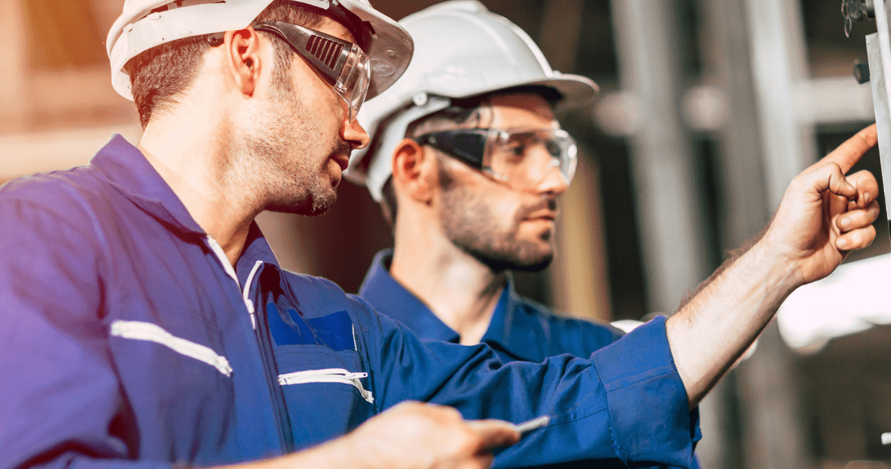 Two Men In PPE Looking Inspecting Equipment  Aspect Ratio 760 400