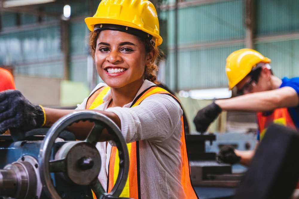 Woman In Yellow Hard Hat And Orange PPE Aspect Ratio 1200 800