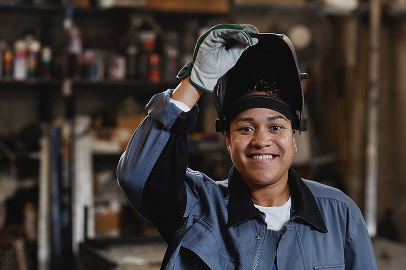 Woman Welding Metal In Workshop