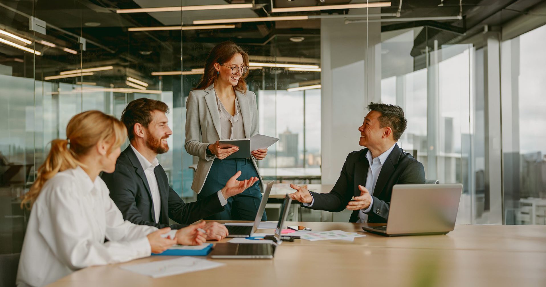 Project professionals discussing plans in a corporate meeting room during a business meeting.