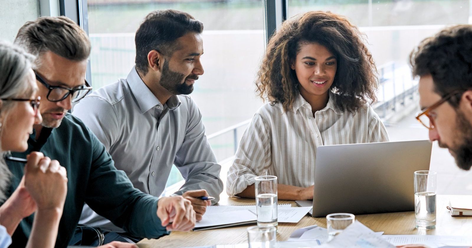 A Group Of People Working Together In Office Setting