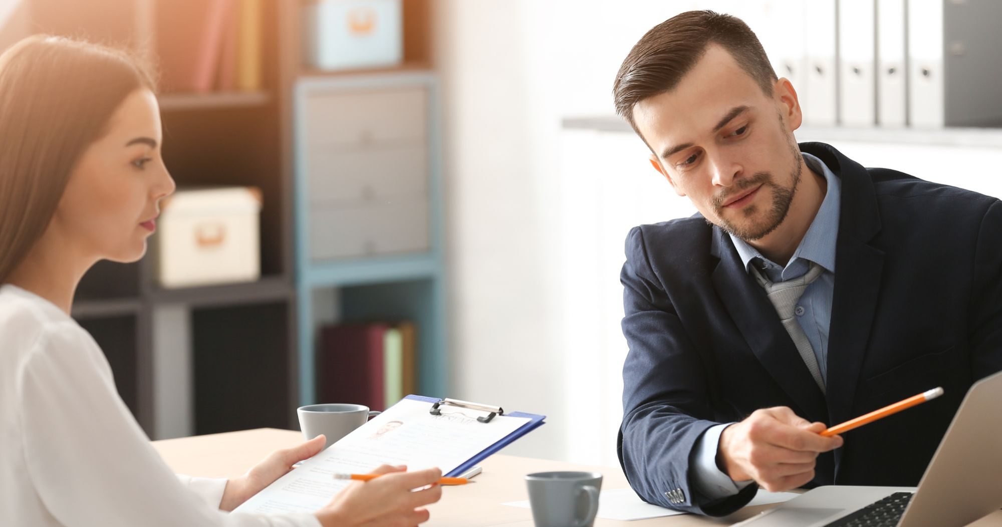 Women And Man Sitting At A Desk With A Laptop