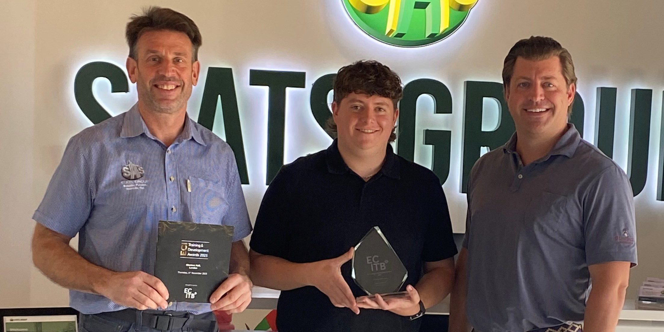 Andy Buckworth From STATS Group Hands Graduate Award To Employee Michael Horgan