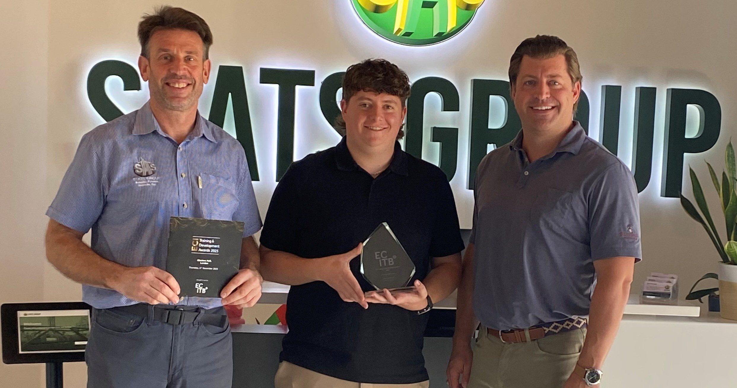 Andy Buckworth From STATS Group Hands Graduate Award To Employee Michael Horgan