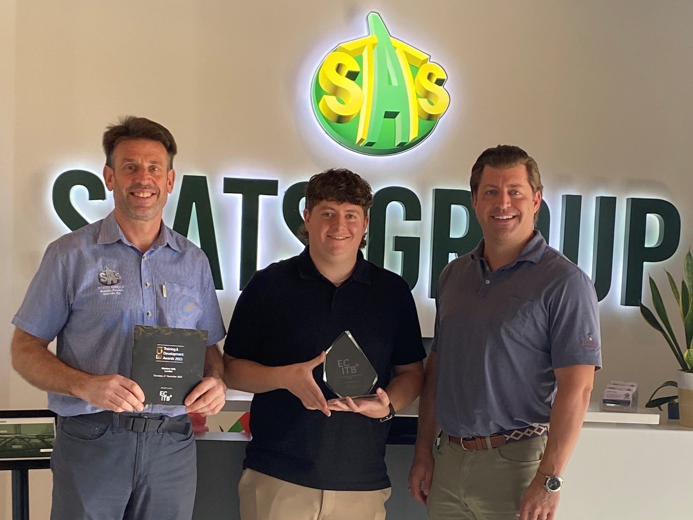 Andy Buckworth From STATS Group Hands Graduate Award To Employee Michael Horgan