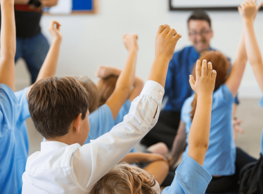 Students with hands raised