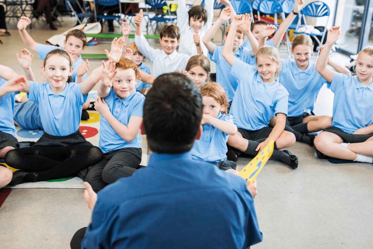 School students with hands in the air