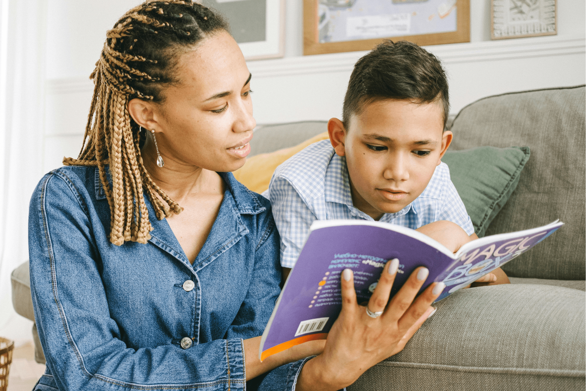Parent and child reading on sofa