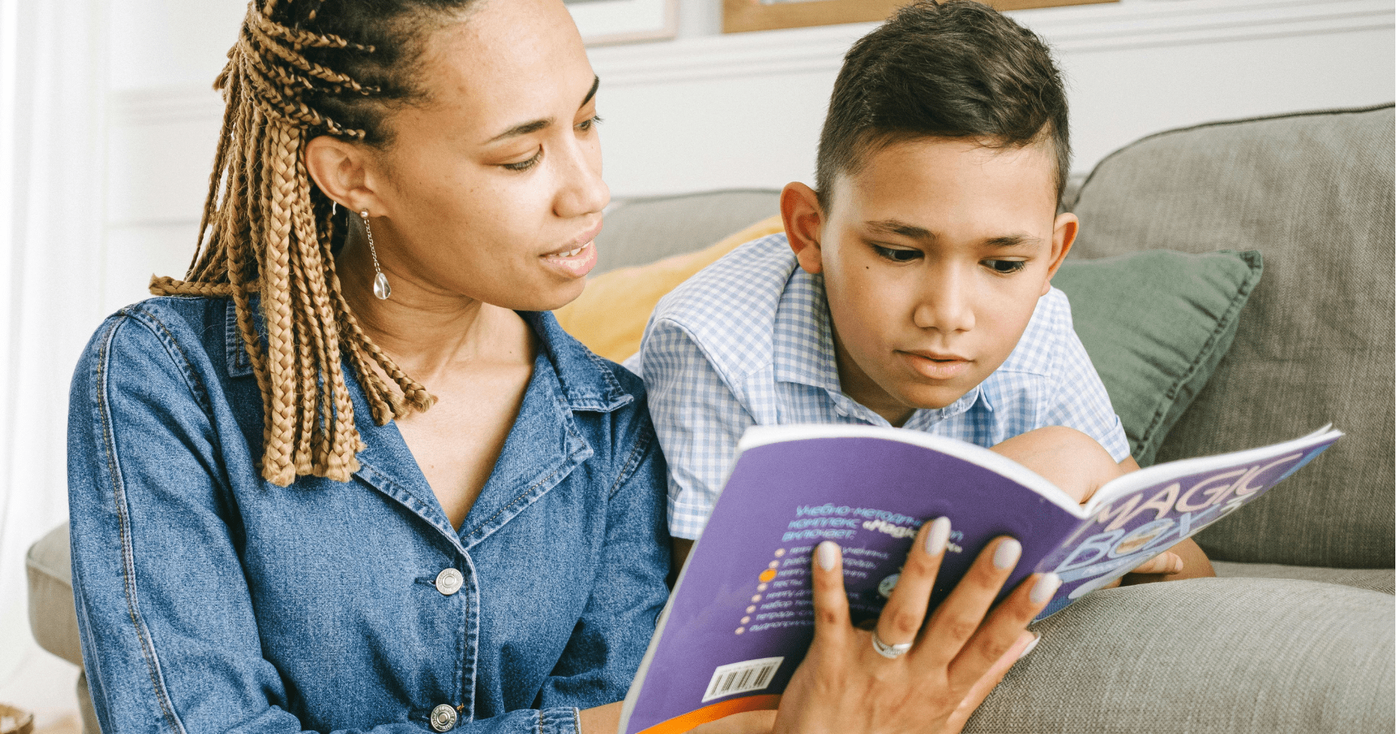 Parent and child reading on sofa