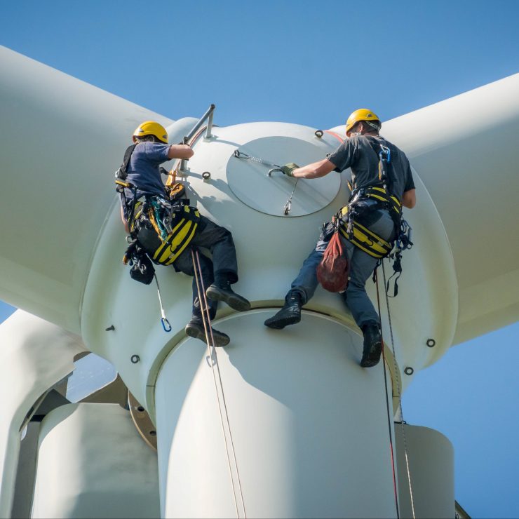 Inspection Engineers Working On A Rotor Blade Of A Wind Turbine