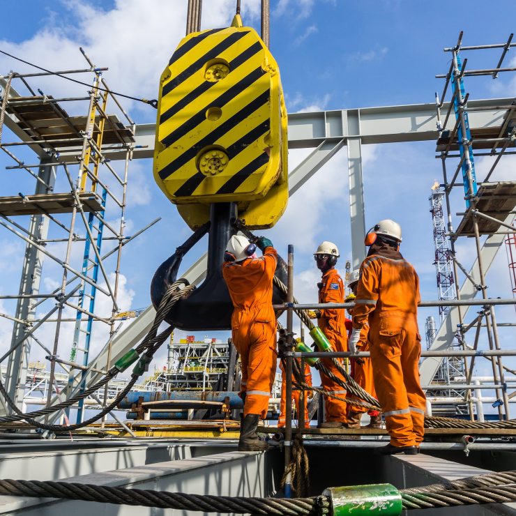 Offshore Workers Performing Inspection To A Crane Hook And Rigging Arrangement Prior To Heavy Lift